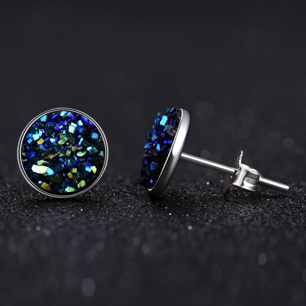 The blue druzy studs close up: crushed crystal set in a silver bezel
